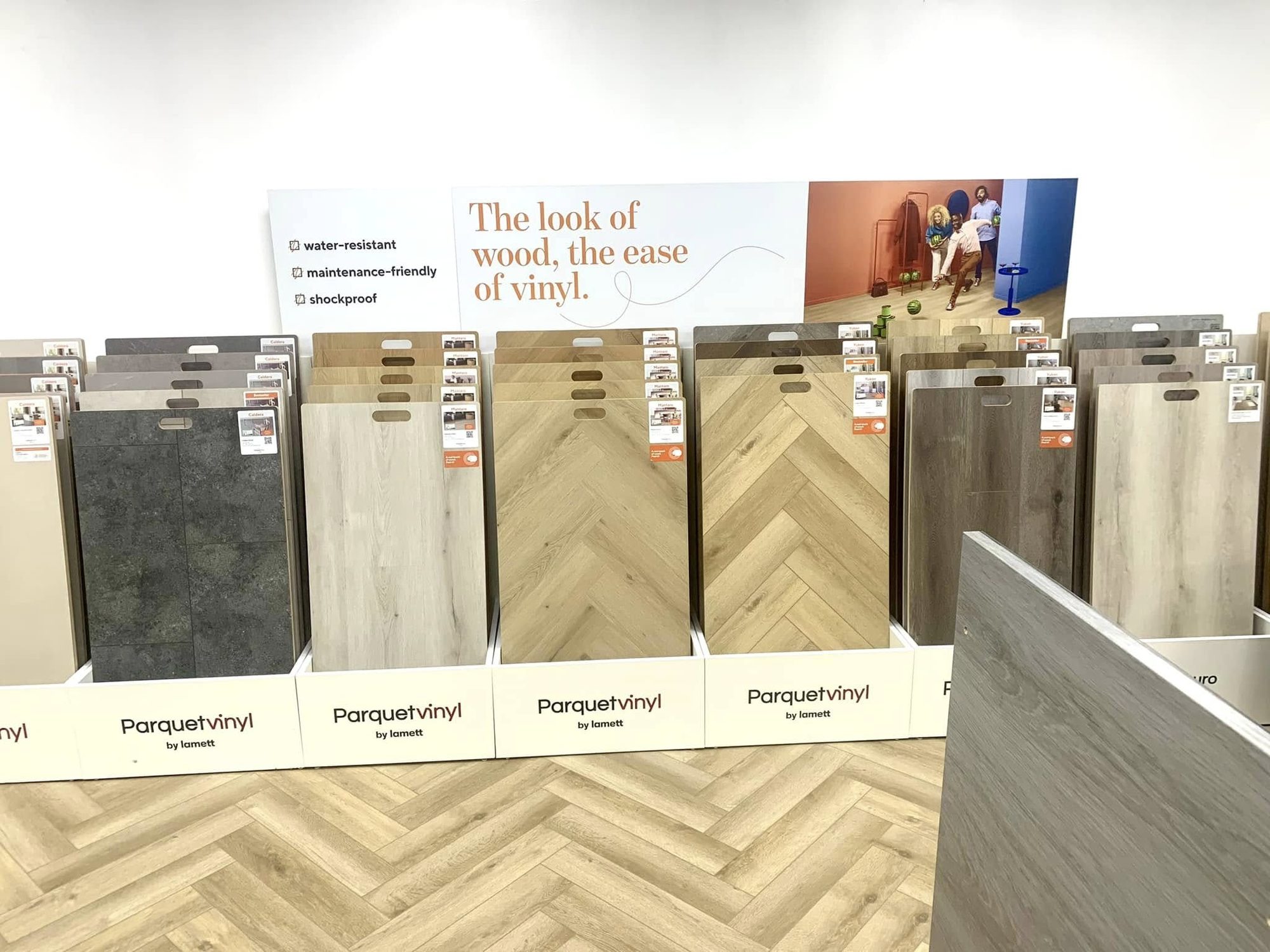 Luxury vinyl tile display showing wood-effect parquet and herringbone LVT planks in Keith