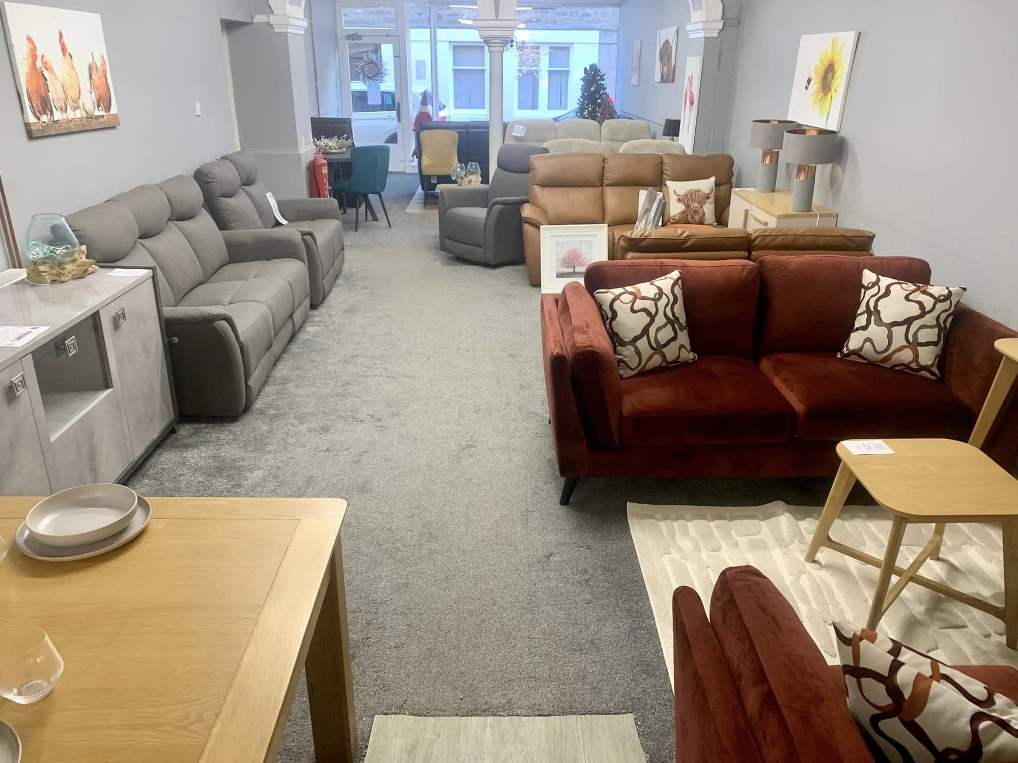 Long showroom gallery of leather and fabric sofas at Taylor's of Buckie