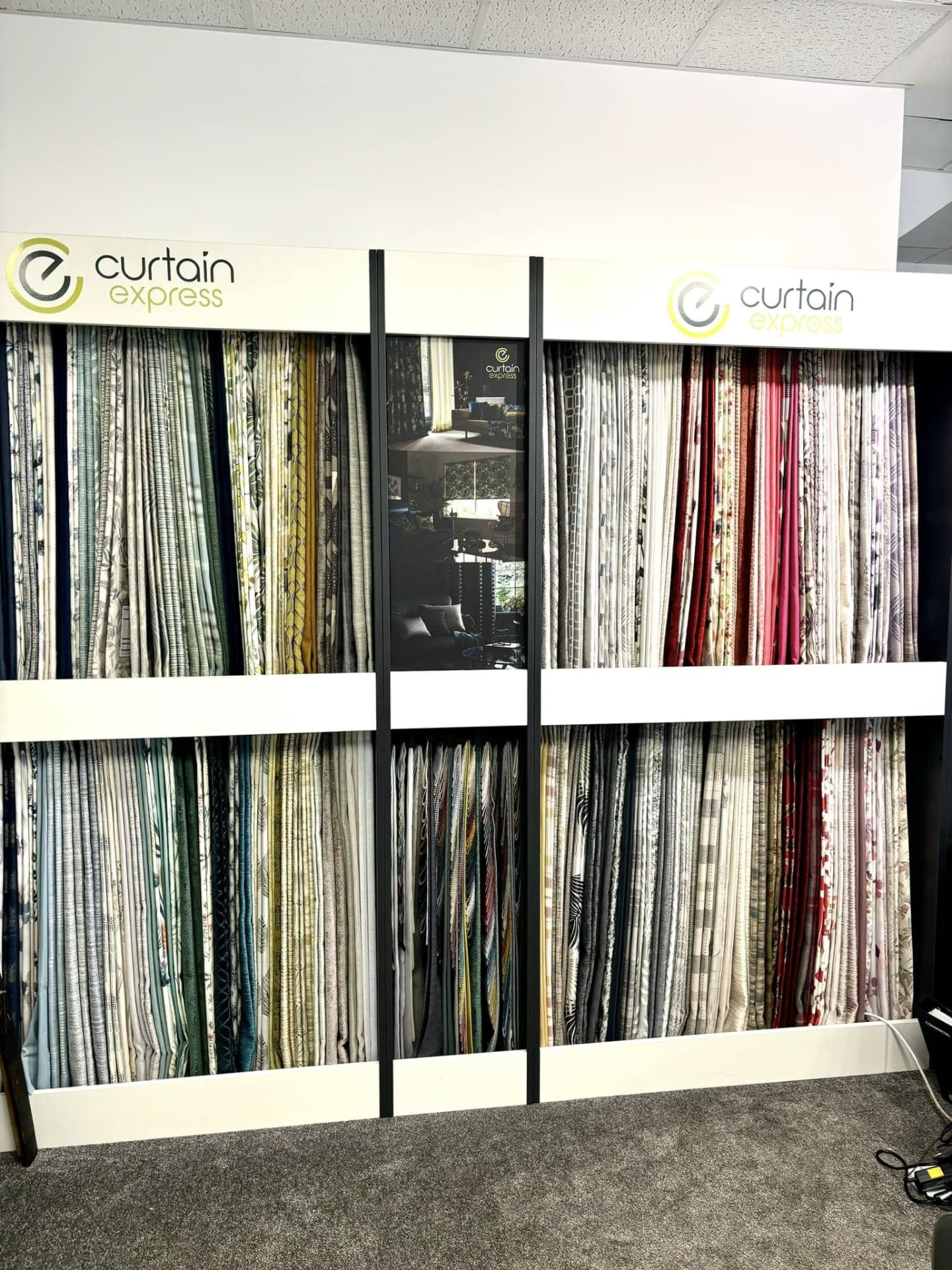 Curtain fabric sample wall in the Keith showroom with hundreds of made-to-measure curtain fabrics