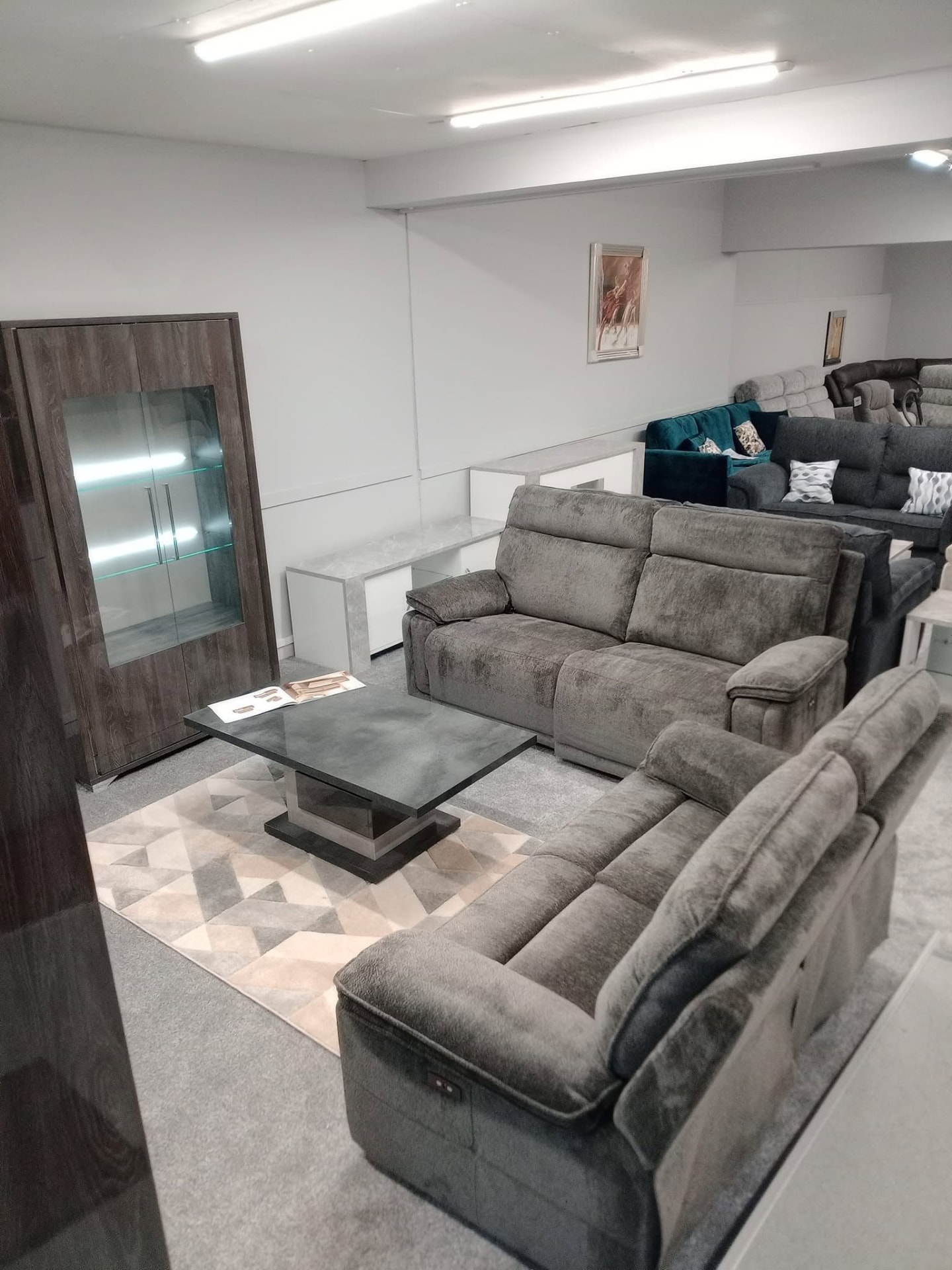Grey chenille corner sofas on display in the Buckie sofa showroom