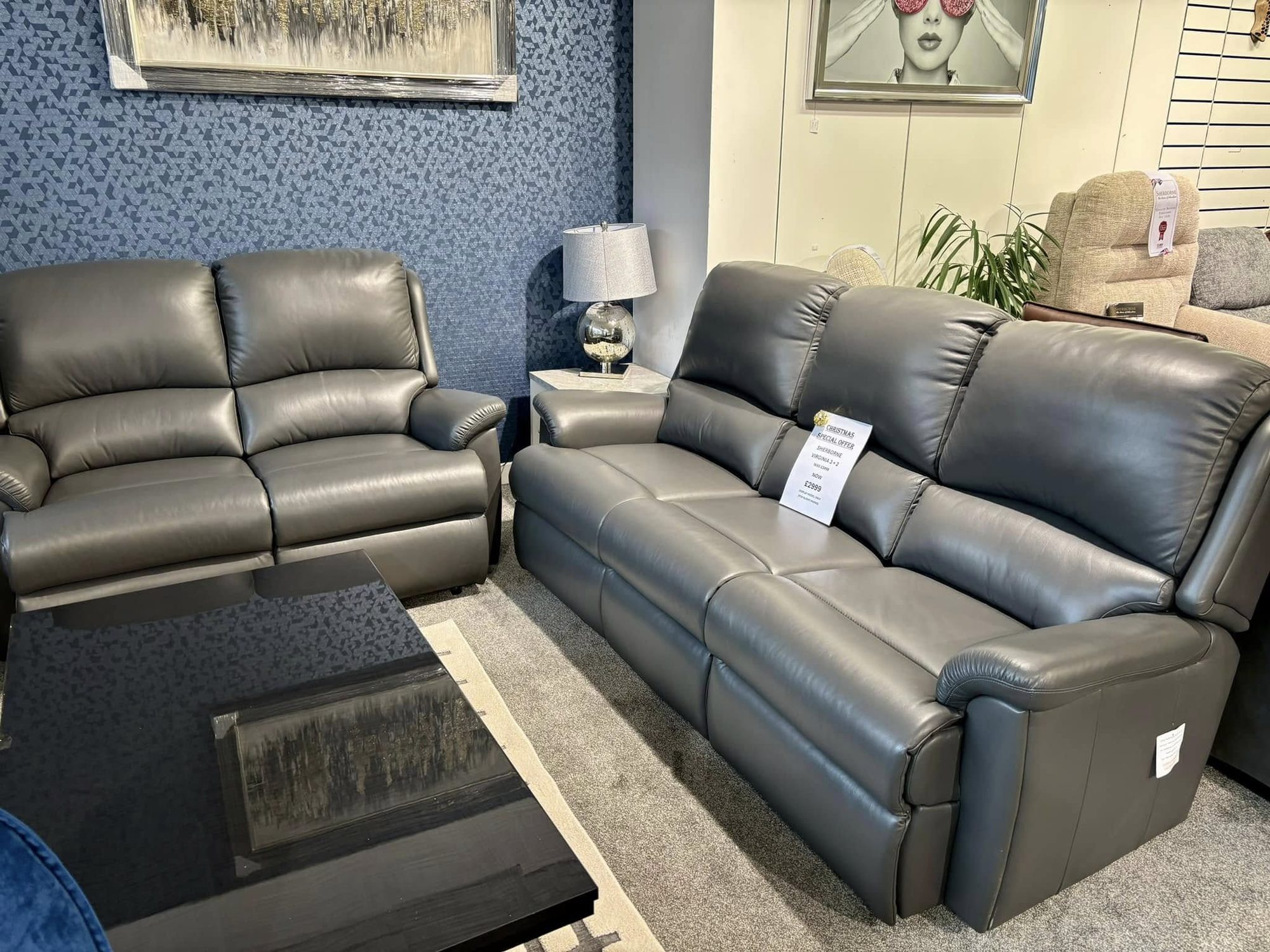 Grey leather three-seater and two-seater sofa suite