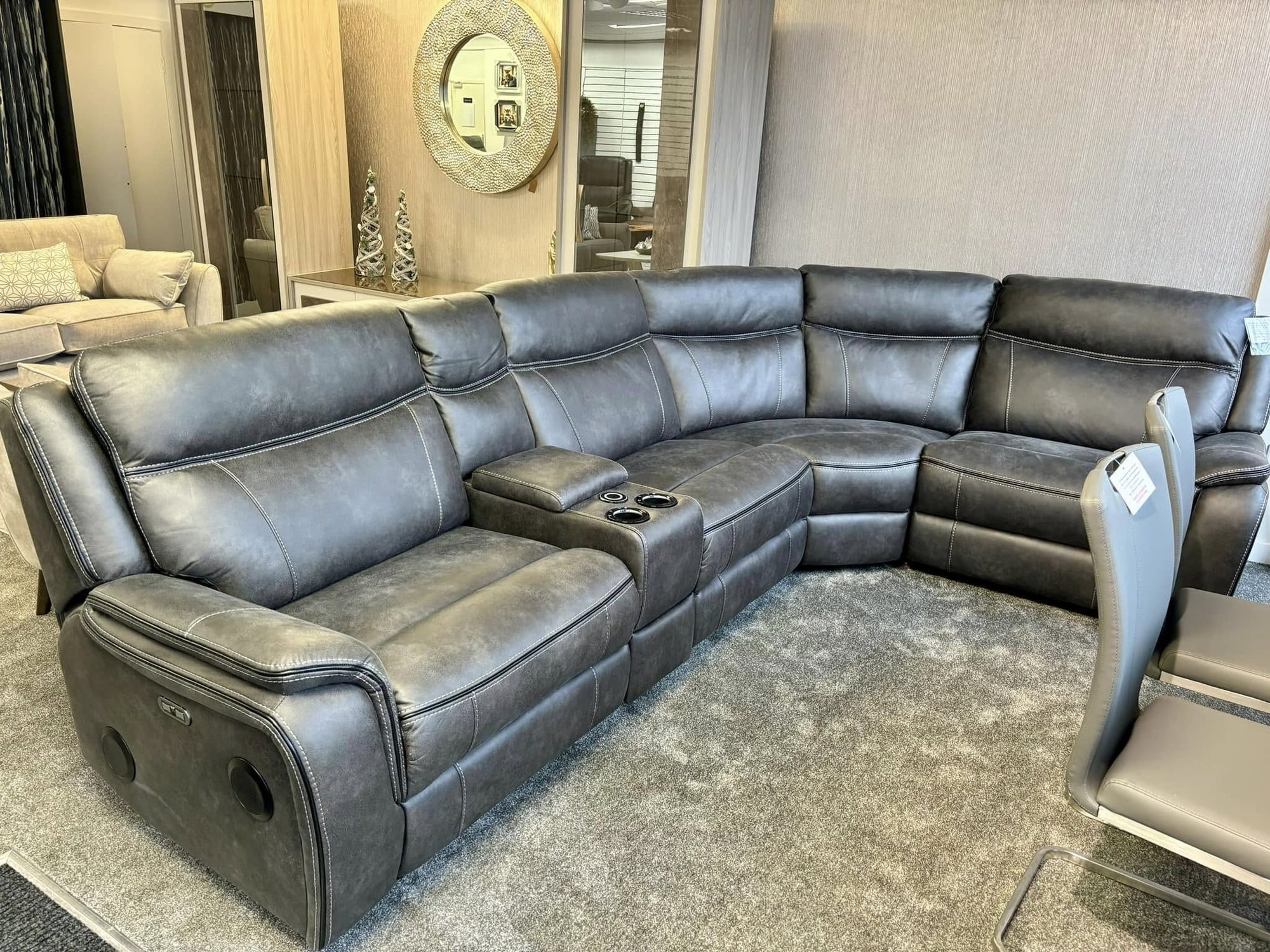 Grey leather corner recliner sofa with built-in cup holders and speakers