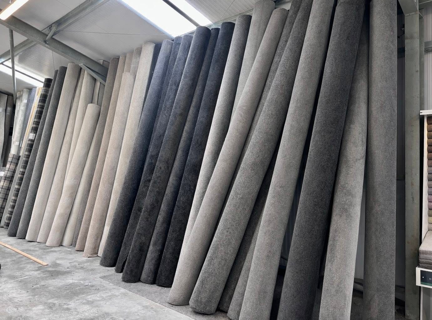 Rolls of grey and neutral carpet in stock at the Taylor's of Keith flooring warehouse