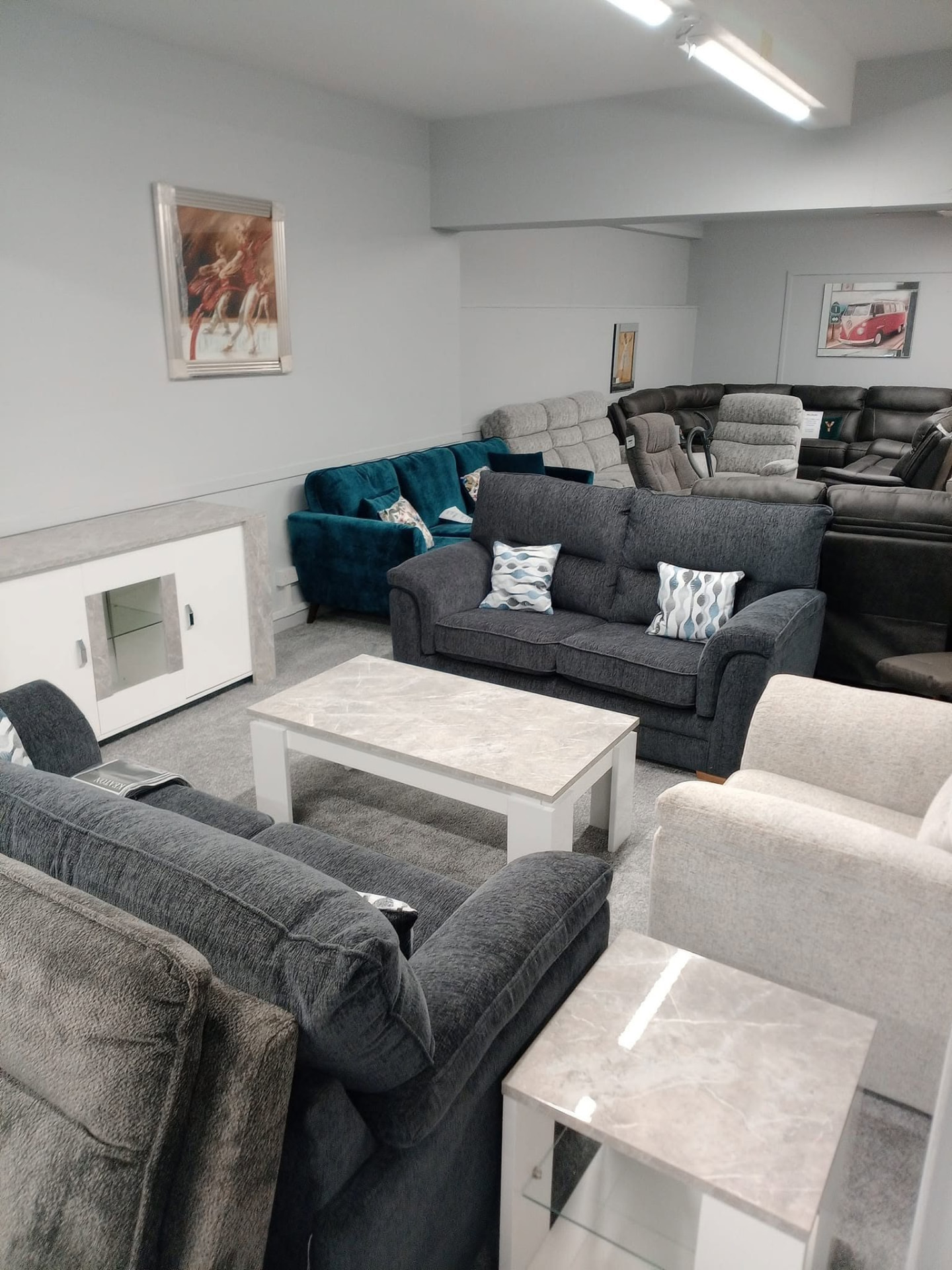 Grey and teal fabric sofa collection on the Buckie showroom floor