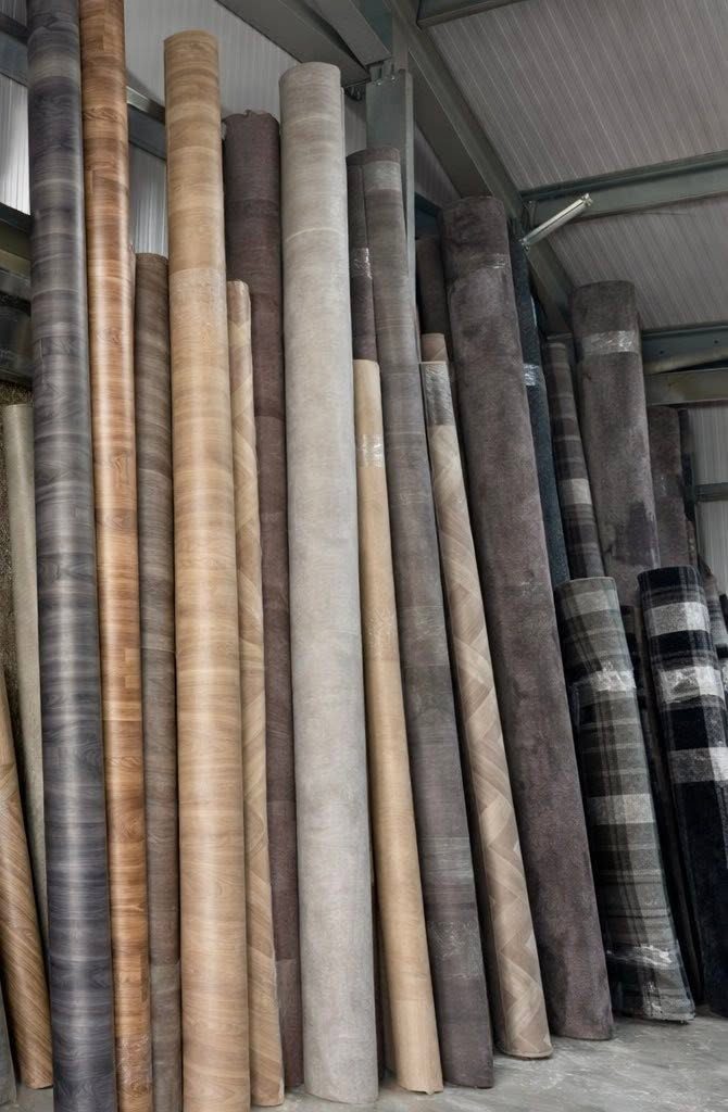 Rolls of sheet vinyl flooring in wood and tile designs held in stock in Keith