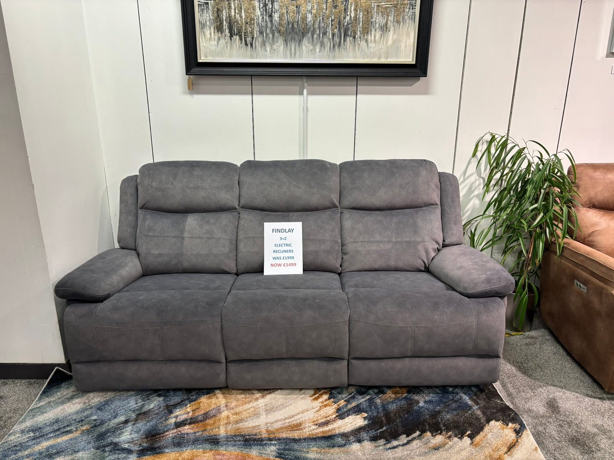 Findlay grey three-seater electric recliner sofa in the sofa showroom